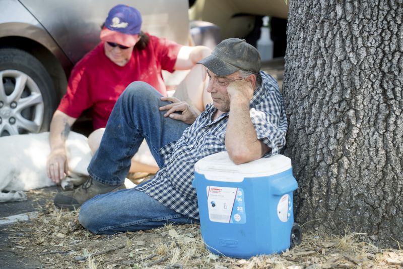 wildfire evacuees rest outside a Red Cross center for Detwiler fire evacuees in Oakhurst, Calif.