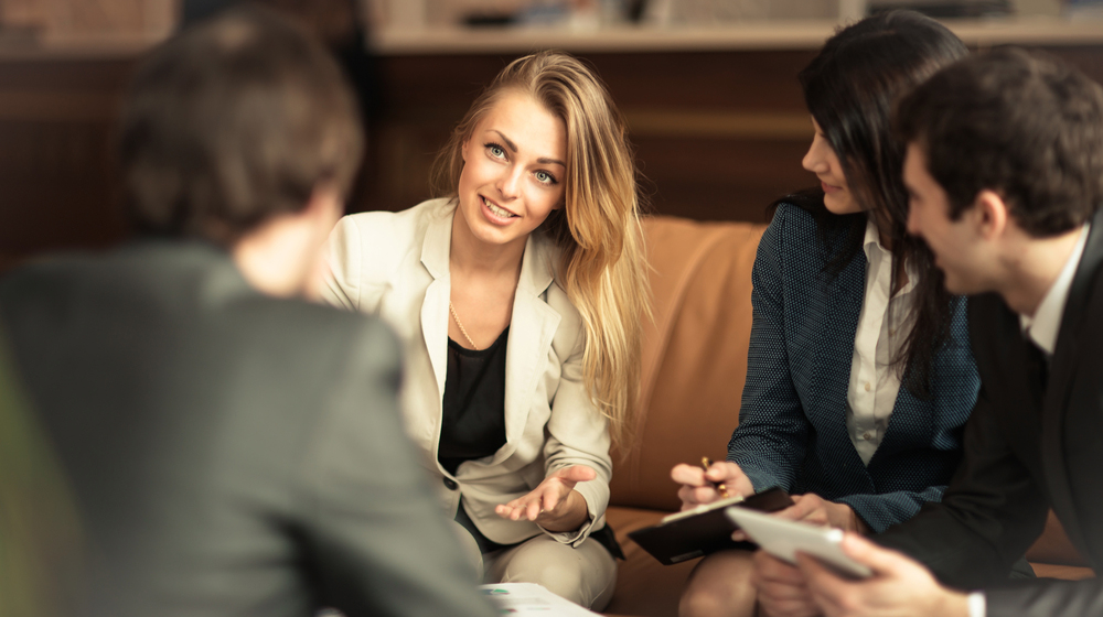 woman speaking to a small group of millennials