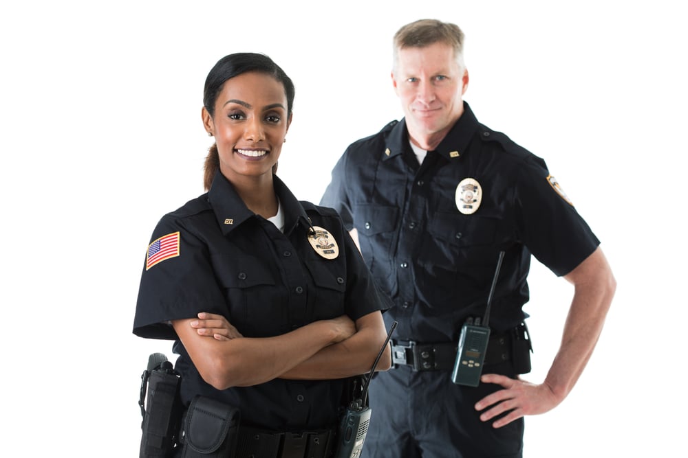 Black female police officer white male police officer smiling