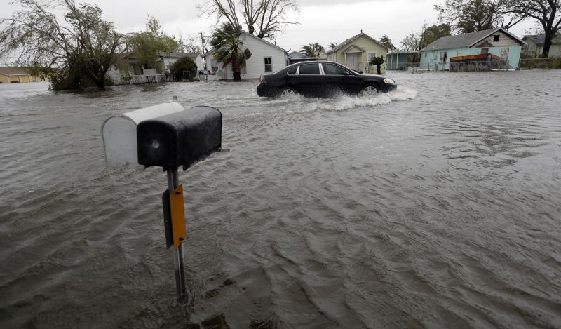 A drives moves through flood waters left behind by Hurricane Harvey