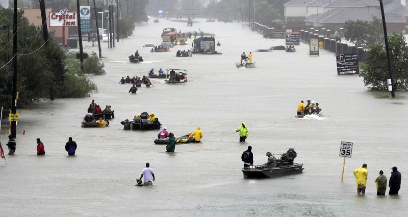 Rescue boats fill a flooded street