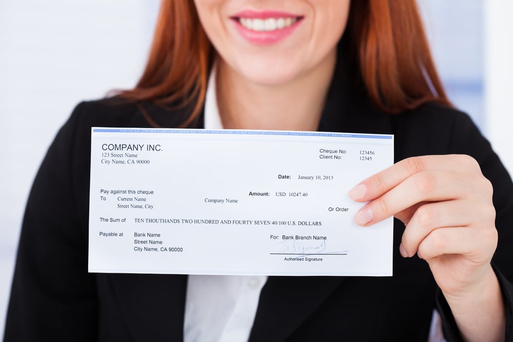 Business woman holding check from company