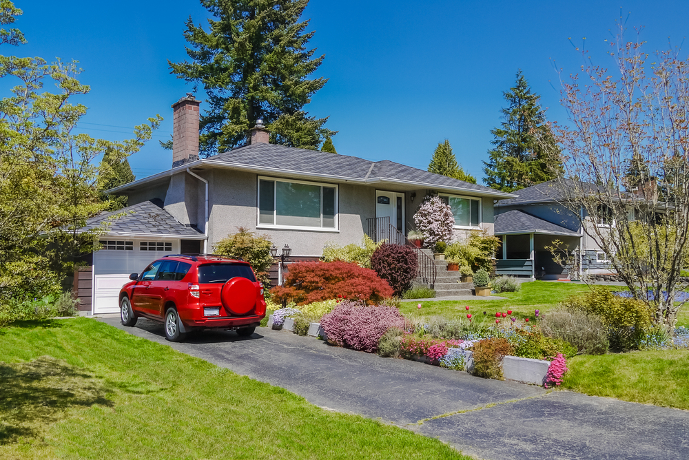 Red Toyota in front of a house