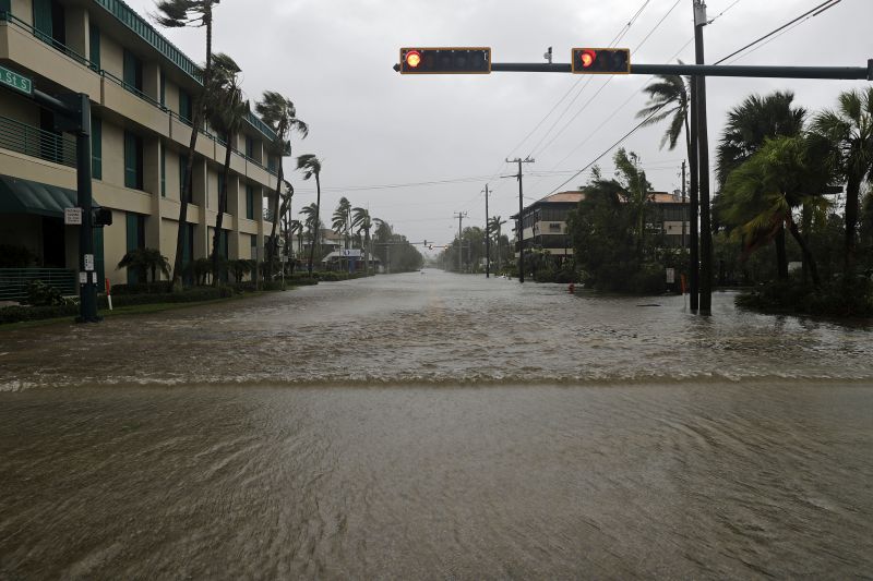 Water floods a street in the business district as Hurricane Irma passes through Naples, Fla.