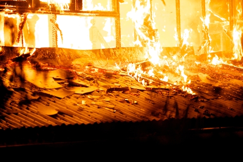 burning house fully engulfed by fire