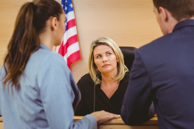 Female lawyer, male lawyer, female judge in courtroom