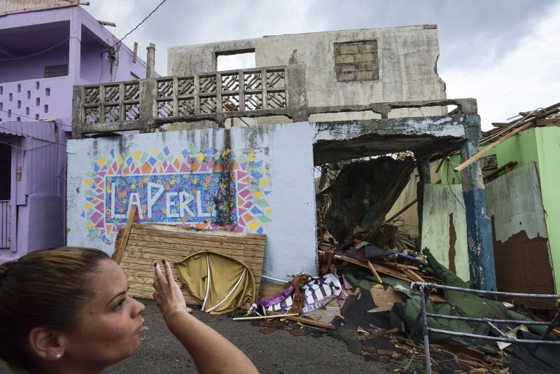 Yashira Gomez, president of La Perla community board shows part of the devastation left by Hurricane Maria