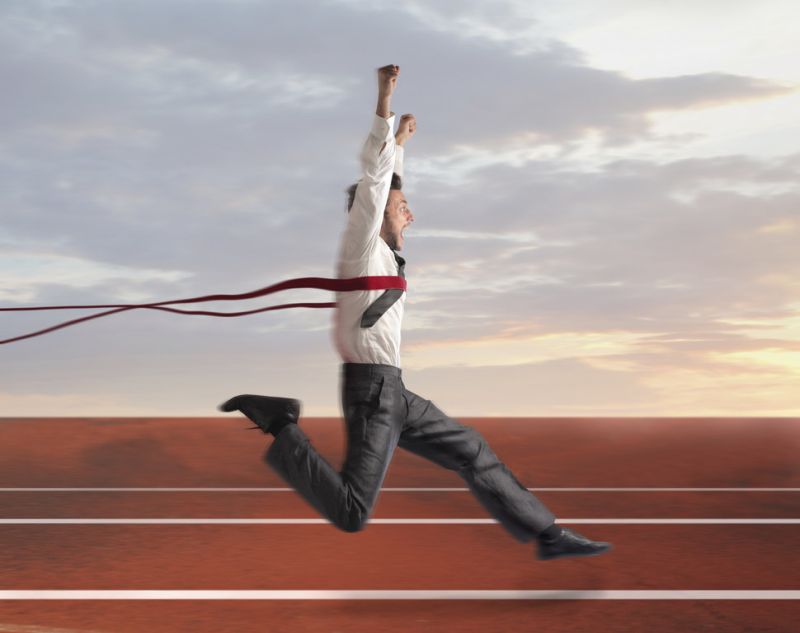 Businessman crossing the finishing line