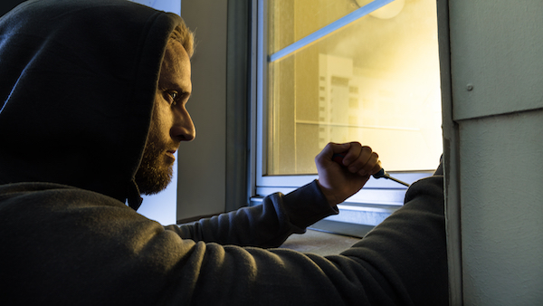 Burglar opening a window