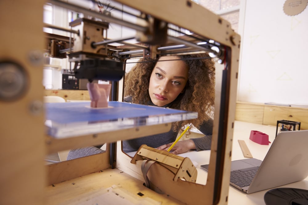 Woman printing on a 3D printer