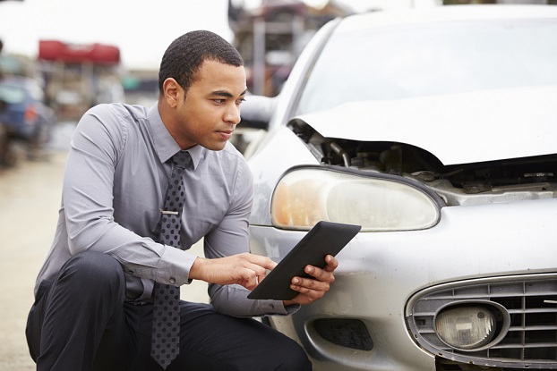 Young insurance adjuster using a tablet