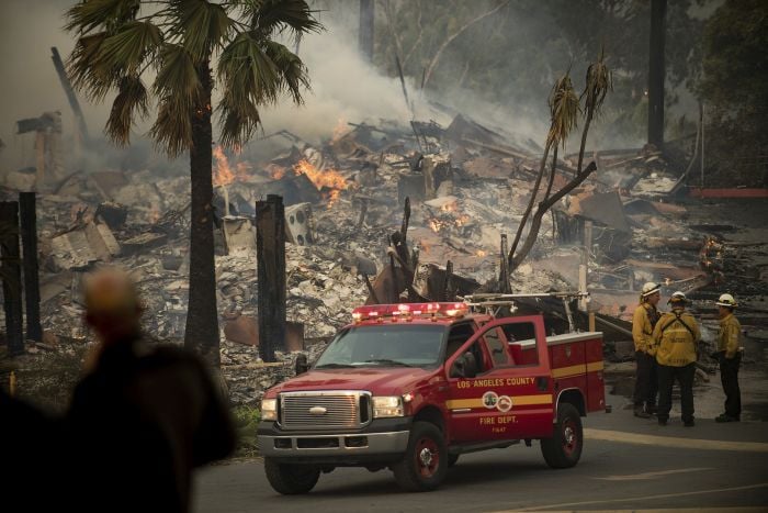 An apartment complex burns as a wildfire rages in Ventura, Calif