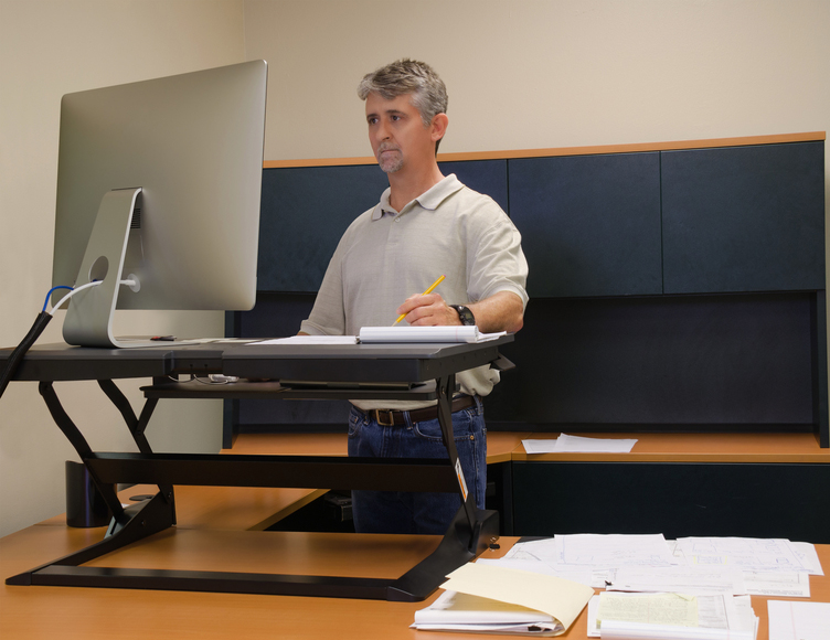 Man working at standing desk in office