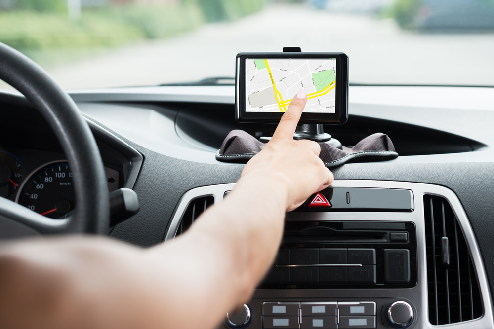 Woman's hand using GPS while driving