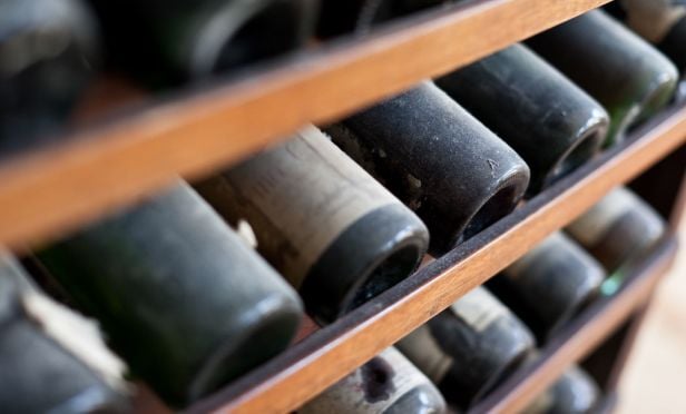 Dusty wine bottles on a rack