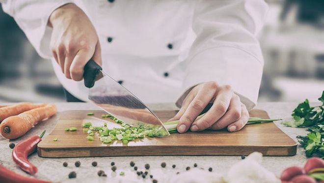 Chef cutting vegetables.