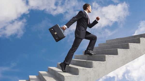 Insurance businessman climbing stairs to success