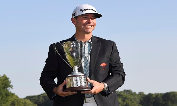 Chez Reavie, winner of the Travelers Championship golf tournament poses with the trophy (Photo: AP Photo/Jessica Hill)