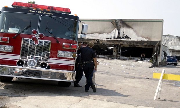 A commercial tenant's exposure after a fire in a leased workplace is the possible loss of use of that space. Here, firefighters survey the site of a deadly furniture store fire in Charleston, South Carolina. (Mahmood Fazal/Bloomberg News)