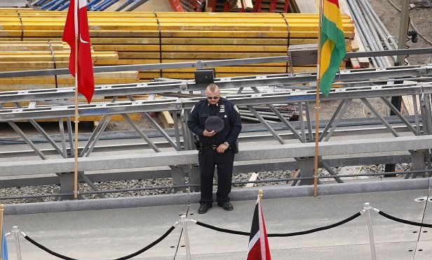A first responder observes a moment of silence during a ceremony at Ground Zero, the 16-acre World Trade Center site, in New York, U.S., on Thursday, Sept. 11, 2008. (Photo: Andrew Harrer/Bloomberg News)