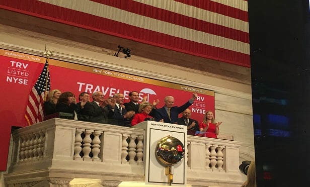 Joan Woodward, center, stands with other executives from Travelers as she rings the opening bell at the New York Stock Exchange. (Photo: Denny Jacob) 