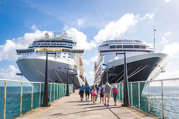 Cruise-ships-side-by-side-at-pier-with-passengers
