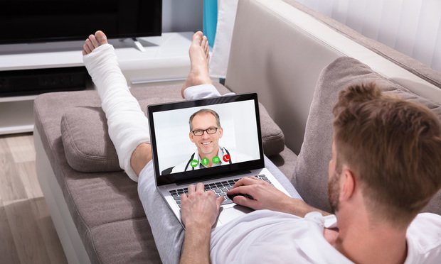 Man-on-couch-bandaged-leg-video-doctor visit
