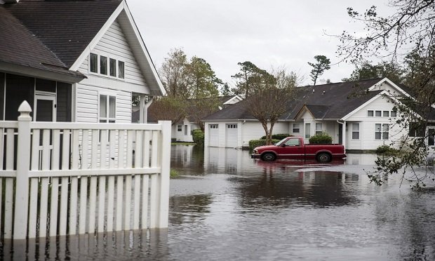 Flood insurance suffers from some ill-informed, preconceived notions. As a result, 57 million homes in the United States have significant flood exposure. Here, A truck sits partially submerged in a flooded North Carolina neighborhood after Hurricane Florence. (Alex Wroblewski/Bloomberg)