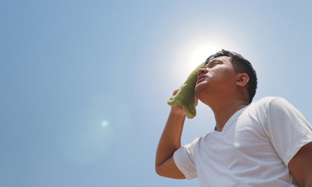 Worker sweating in glaring sun. A study that compared weather data with daily number of workers' compensation claims in Adelaide, South Australia from 2003-2013 found claims increased under moderate to extreme temperatures, while cold conditions resulted in delayed effects. (Credit: Shutterstock.com)