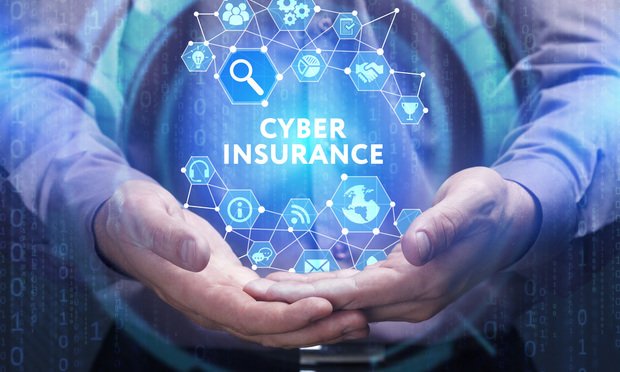 A person holds their hands in front of them, holding a graphic that says "cyber insurance."
