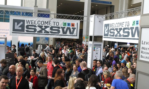 FILE - SXSW Interactive and Film Festival attendees crowd the Austin Convention Center on March 9, 2013, in Austin, Texas. After the pandemic forced the South by Southwest Film Festival to turn virtual the last two years, the Austin, Texas, festival is plotting a largely in-person event this March, with the premieres of the third season of Donald Glover's 