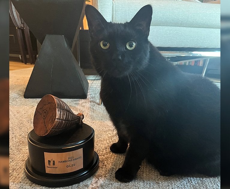 Giles the Cat poses with its 2023 Hambone Award. In addition to the trophy, Giles' owners received a gift card and a donation made in the cat's name a pet charity. Credit: Nationwide