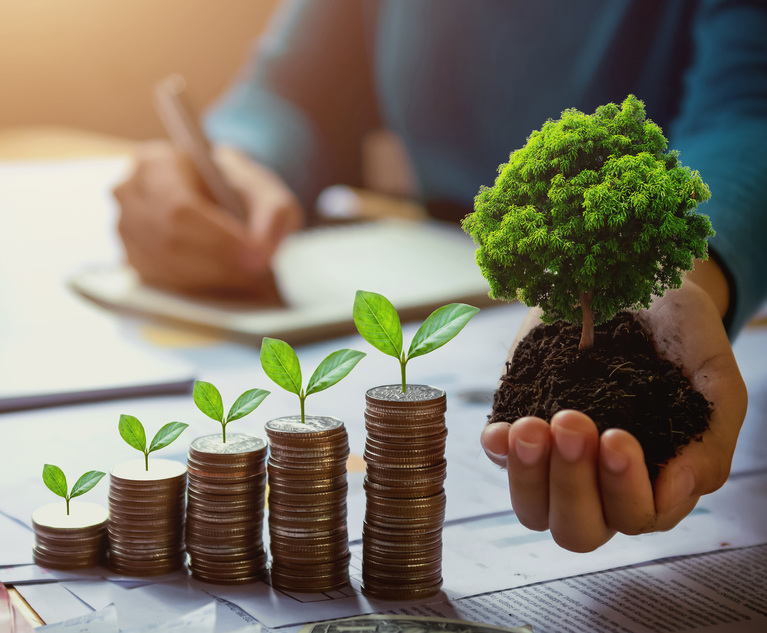 business woman hand holding tree with plant growing on coins. concept saving money and earth day. Credit: lovelyday12/Adobe Stock