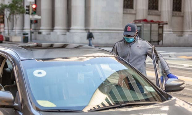 Uber driver Edward Nkansnh on California street in San Francisco on April 3, 2020. Nkansnh has suffered substantially less riders, instead replacing it with Uber Eats food delivery. (Photo: Jason Doiy/ALM)