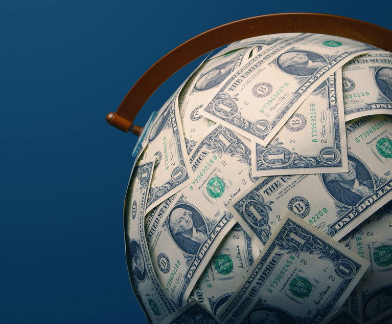 The image of a globe covered by one dollar bills.