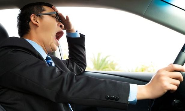 Drowsy, yawning male driver.