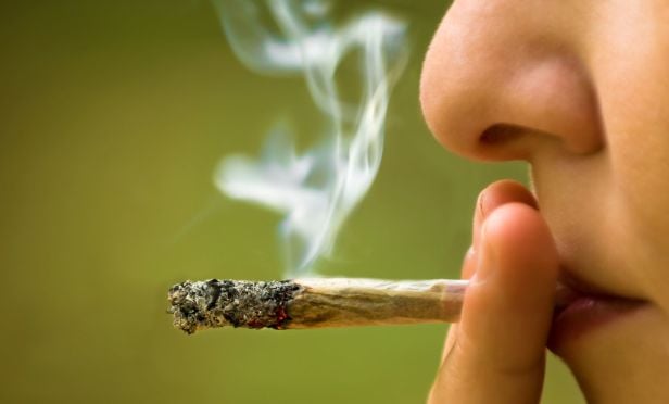 woman smoking a marijuana cigarette