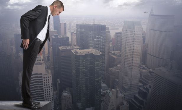 Man on ledge looking down.