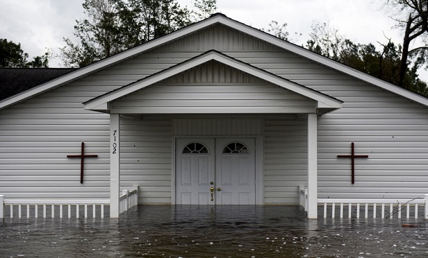 In many cases, churches are only occupied once or twice a week, so property damage can go undetected. This one in North Carolina sustained damage in September 2018 as a result of the torrential rains and flooding unleashed by Hurricane Florence. (Photo: Callaghan O'Hare/Bloomberg)