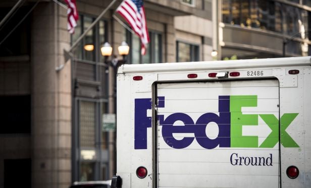 A Fedex Corp. delivery truck sits parked on a street in downtown Chicago, Illinois