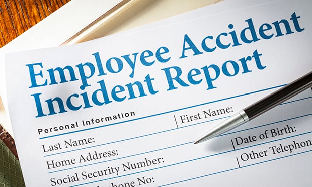 Employee Accident Report Claim Form on desk with pen