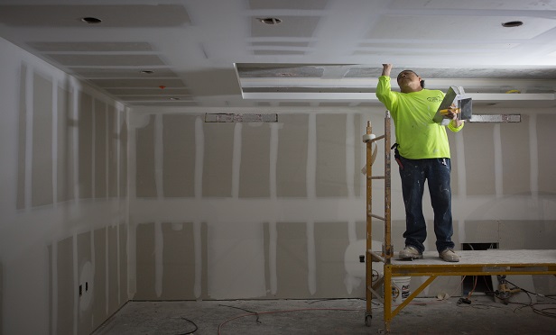 A worker spackles the ceiling of a flood proof room during construction of the 121 Marina residential condominium complex designed to withstand extreme weather at Ocean Reef Club in Key Largo, Florida, U.S., on Wednesday, April 18, 2018. (Photo: Alicia Vera/Bloomberg)