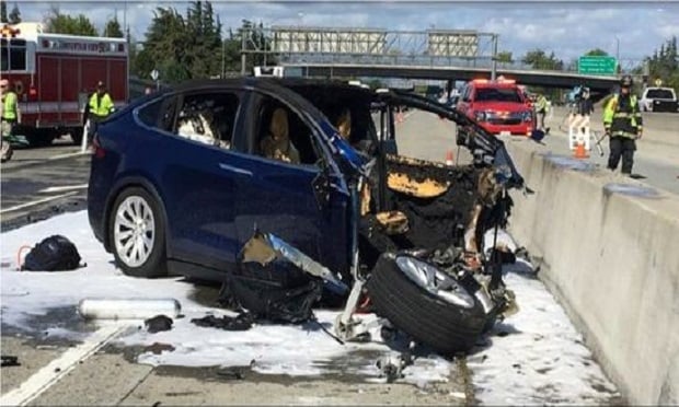 Emergency personnel work a the scene where a Tesla electric SUV crashed into a barrier on U.S. Highway 101 in Mountain View, Calif. The test results by AAA released Thursday, Nov. 15, 2018, come after several highly publicized crashes involving Tesla vehicles that were operating on the company's system named 