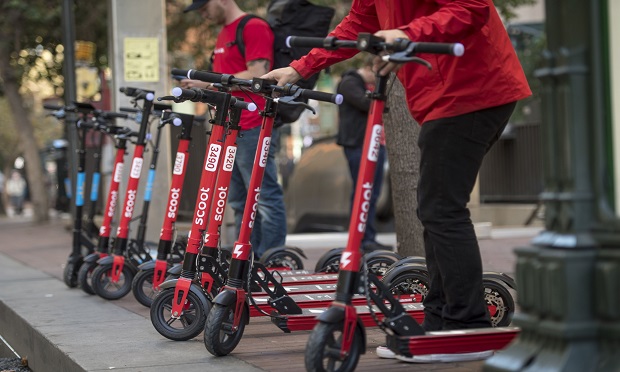 Scoot Networks Inc. kick electric scooters stand on Market Street in San Francisco, California, U.S., on Monday, Oct. 15, 2018. Scoot Networks Inc. along with Skip Transportation Inc. were the two startups that received permits from the city of San Francisco to operate scooter networks starting today. (Photo: David Paul Morris/Bloomberg)