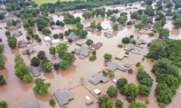 This Tuesday, May 28, 2019, aerial photo shows flooded homes along the Arkansas River in Sand Spring, Okla. Communities that have seen little rain are getting hit by historic flooding along the Arkansas River thanks to downpours upstream that have prompted officials to open dams to protect some cities but inundate others with swells of water. (Photo: DroneBase via AP)
