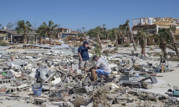 Residents survey debris after Hurricane Michael hit in Mexico Beach, Florida, U.S., on Friday, Oct. 12, 2018. Search-and-rescue teams found at least one body in Mexico Beach, the ground-zero town nearly obliterated by Hurricane Michael, an official said Friday as the scale of the storm's fury became ever clearer. (Photo: Zack Wittman/Bloomberg)