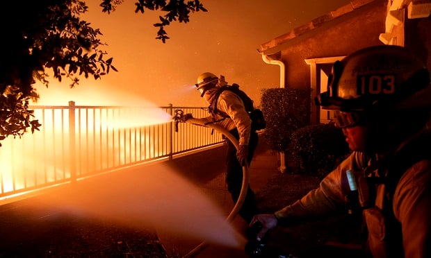 In this Thursday, Oct. 10, 2019, photo, Los Angeles City firefighters battle the Saddleridge fire near homes in Sylmar, Calif. (Photo:AP Photo/Michael Owen Baker)