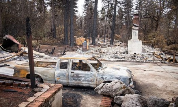 A burned-out vehicle is seen near destroyed homes in Paradise, California, U.S., on Monday, Nov. 26, 2018. The nation's deadliest wildfire in a century known as the Camp Fire that killed at least 85 people and burned over 14,000. (Photo: David Paul Morris/Bloomberg)