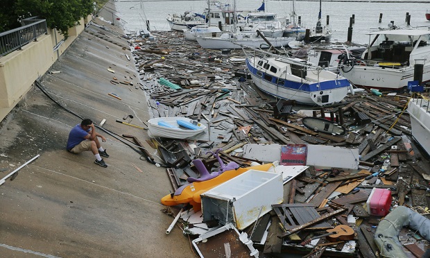 Allen Heath surveys the damage to a private marina after it was hit by Hurricane Hanna, Sunday, July 26, 2020, in Corpus Christi,Texas. Heath's boat and about 30 others were lost or damaged. (AP Photo/Eric Gay)