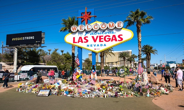 Flowers and gifts at the memorial park by Mandalay Bay on the Vegas Strip at the Las Vegas sign to remember victims killed in the Las Vegas mass shooting. (Photo: evenfh/Shutterstock)